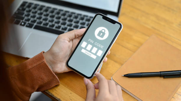 istock Woman hands entering the PIN code on the smartphone. Data security concept 2022191427