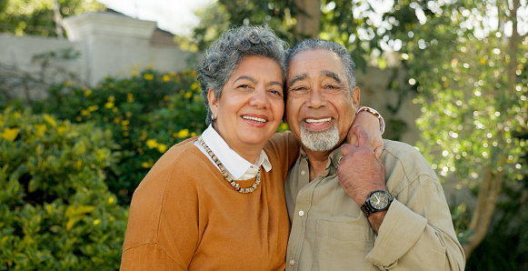Love, smile and portrait of senior couple in garden for connection, relaxing and bonding for enjoyment. Elderly people, face and happy in nature for romance, care and date outdoors in retirement