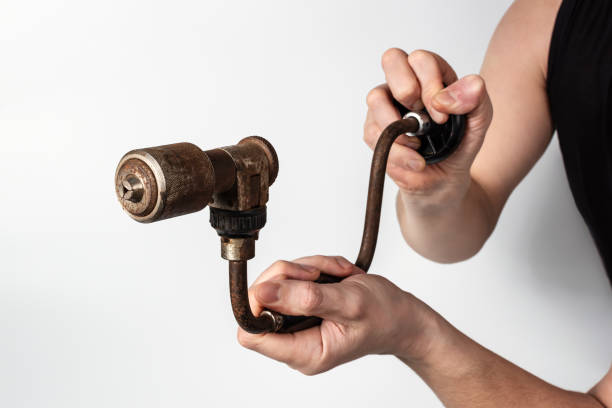 Close-up of a hand drill in the hands of a man stock photo
