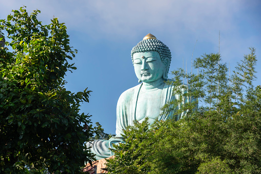 Kaohsiung, Taiwan - April 29, 2019: The Fo Guang Big Buddha and the Four Noble Truths Stupas in the Fo Guang Shan Buddha Museum on blue sky background. Taiwan is a popular tourist destination of Asia.