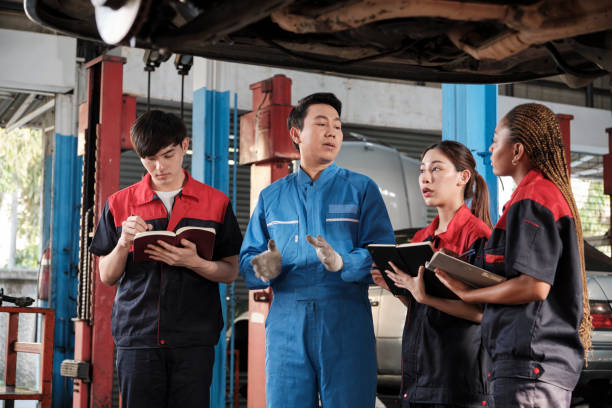istock A supervisor engineer is training mechanic workers about car repair at a garage. 2022224295