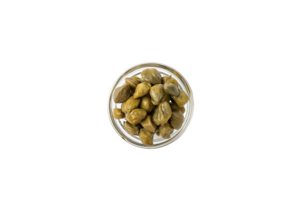 istock Capers isolated on white background. Marinated caper buds, small salted capparis in bowl, fermented food, pickled capers group.Organic spices and seasonings. 2022228029