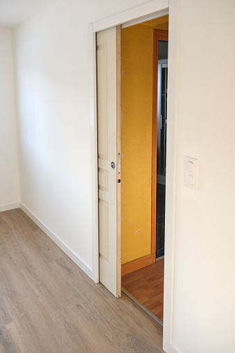 Pocket door in a white plasterboard wall (sliding door inside a wall)