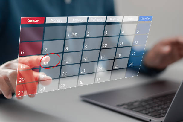 istock Time management concept. Businessman using laptop and manages time on calendar virtual screen interface. Highlight appointment reminders and meeting agenda on the calendar. 2022247414