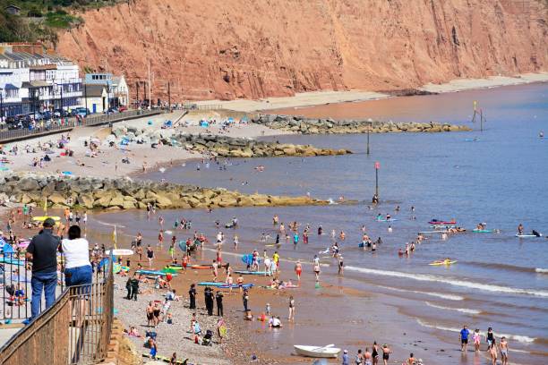 A landscape photograph of Sidmouth Beach in Devon, UK.