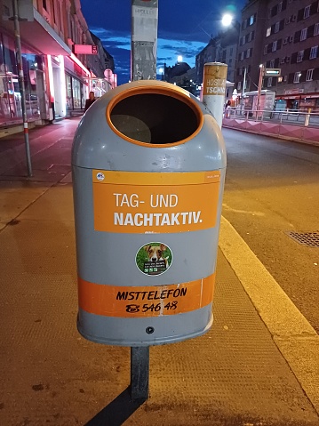 Vienna, Austria - June 7, 2023: Trash bin in sidewalk of Vienna city, Austria in the evening.