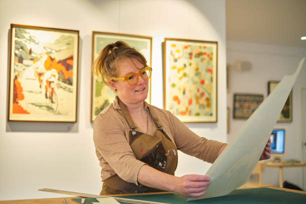 istock Woman proudly contemplates a self work made with screen printing 2022264173