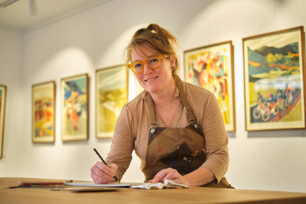 istock Artist writing notes in a paper preparing an exhibition 2022264193