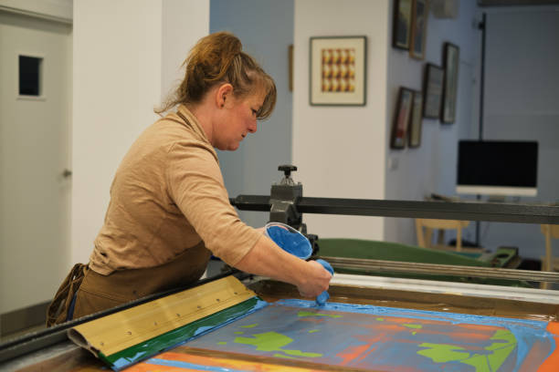 istock Woman using blue marker paint in a serigraphy workshop 2022264709