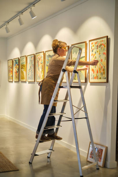 Artist preparing an exhibition with printing creations
