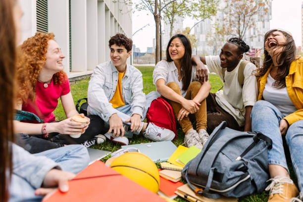 istock Student friendship concept with diverse classmate friends sitting on campus park 2022278899