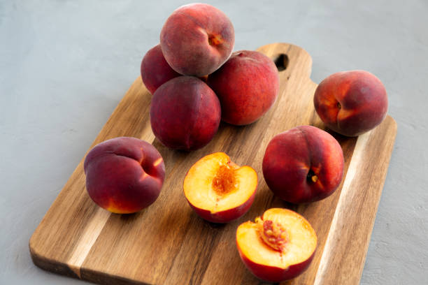 istock Raw Organic Yellow Peaches on a wooden board, low angle view. 2022284723