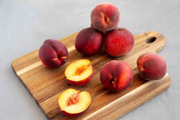 istock Raw Organic Yellow Peaches on a wooden board, low angle view. 2022284733