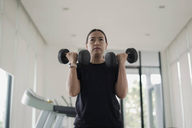 istock Close-up Woman lifting dumbbells 2022285303