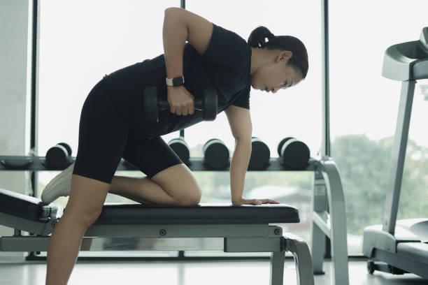 istock Side view woman lifting dumbbells 2022285825