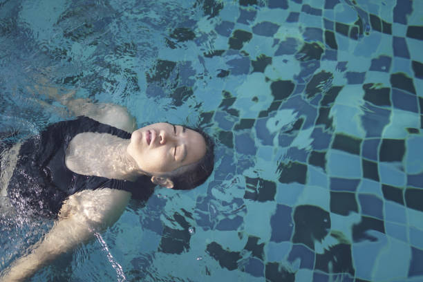 Woman floating in a swimming pool
