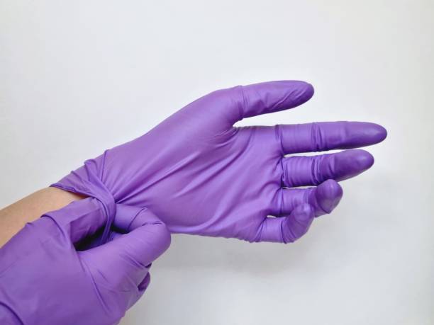 istock Close-up of hands wearing rubber gloves 2022326641