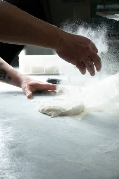 istock Preparing pizza with pizza chef's hands and flour 2022329352