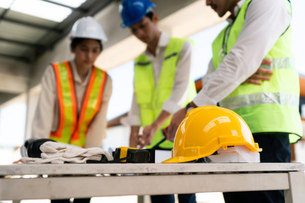 team engineer, foreman, architect meeting for colleagues discussing and checks construction blueprints at onsite