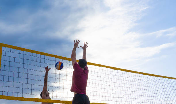 Two beach volleyball players playing beach volleyball with copy space