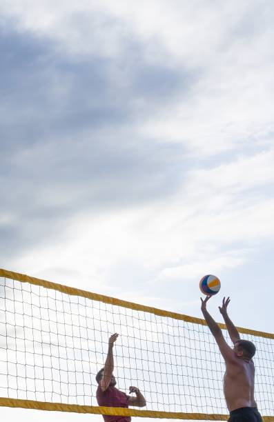 istock Two men playing beach volleyball with copy space 2022331983