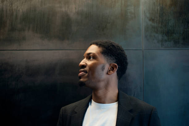 istock Business, thinking and African man with vision, planning or brainstorming startup idea on black wall background. Why, questions and male entrepreneur with career, mockup or problem solving solution 2022336849