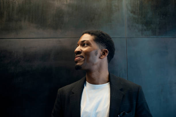 istock Thinking, business and African man with vision, planning or brainstorming startup idea on black wall background. Why, questions and male entrepreneur with career, mockup or problem solving solution 2022336851