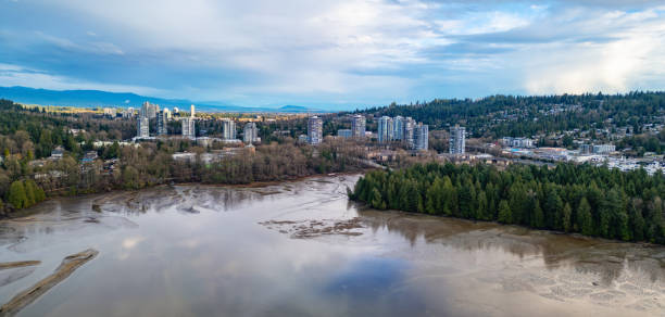 istock City buildings stand tall along the river under a cloudy blue sky 2022342175