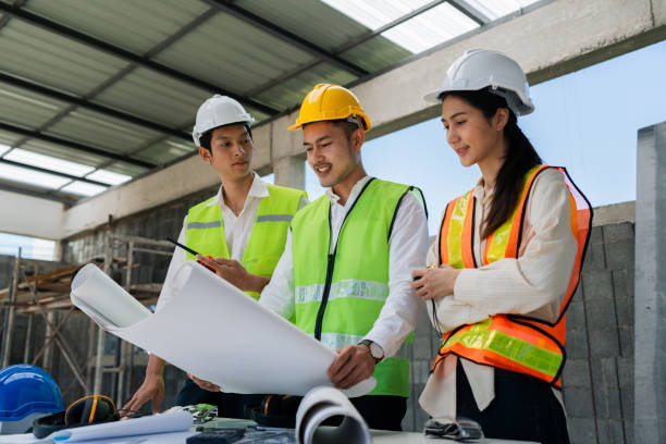 istock team engineer, foreman, architect meeting for colleagues discussing and checks construction blueprints at onsite 2022343259