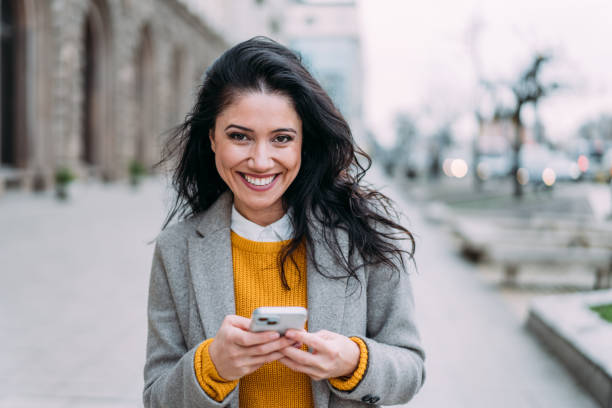istock Woman using smartphone outdoors. 2022343265