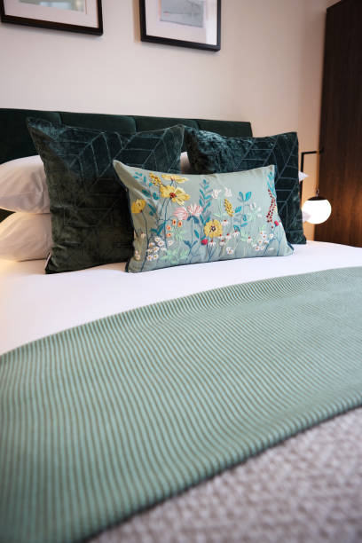 istock Hotel, bedroom and interior patterns of home decor for accommodation with duvet, comforter and pillows. Empty room of bed in house, apartment or resort with linen sheets for luxury in hospitality 2022354470