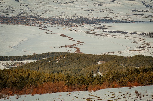 An aerial view of the destruction done by a tornado to a single family house.