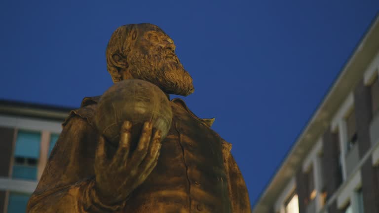 Galileo Galilei Italian scientist bronze sculpture after twilight, Pisa, Tuscany