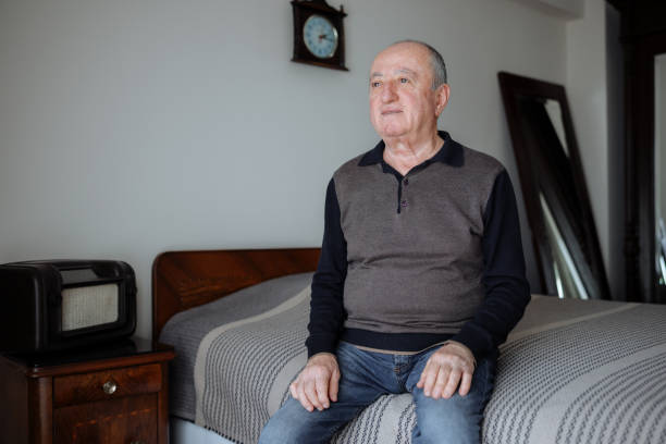 istock Smiling mature man sitting on her living room sofa 2022391686