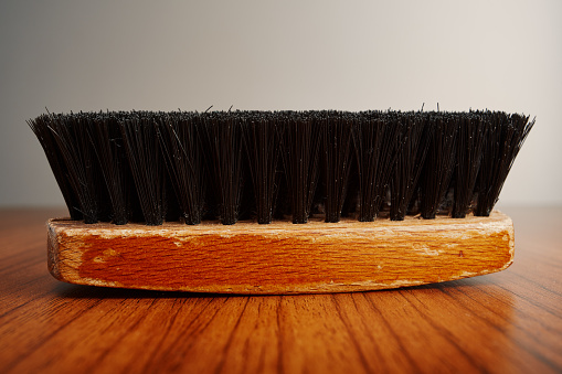 Wooden clothes brush on wooden table