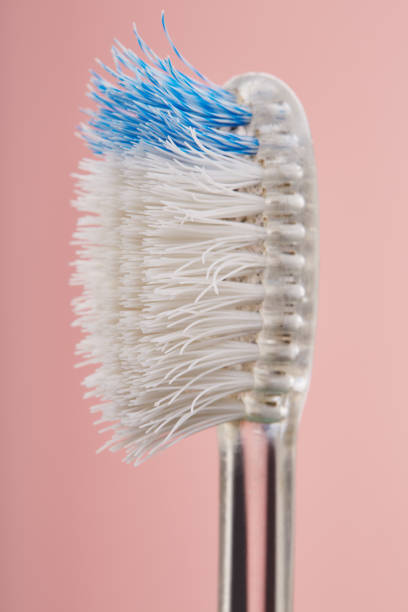Worn out old plastic toothbrush used with bent bristles in bad condition