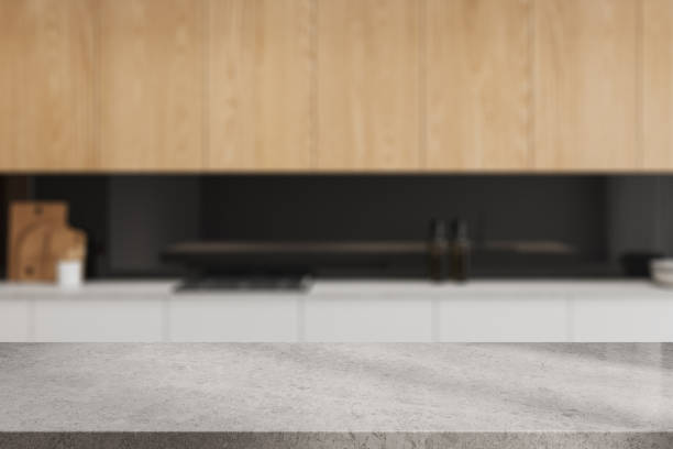 istock Stone countertop on background of kitchen interior with kitchenware. Mockup 2022403911