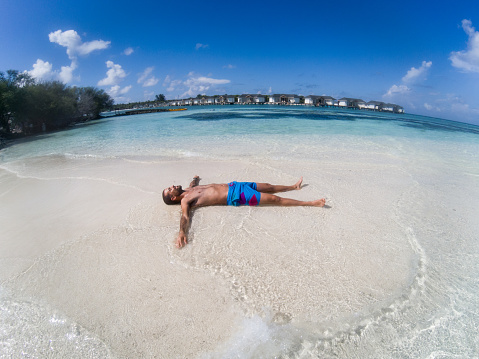 Man enjoying sunny summer sea holidays at Maldives