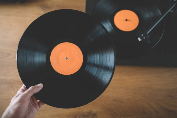 istock Hand holding long play vinyl record 2022418024
