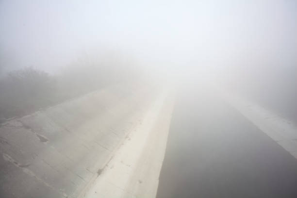 Diversionary channel on a foggy day in the italian countryside seen from above
