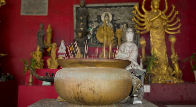 Old historical metal Censer at Buddhist temple, praying in temple, people lights incense and praying