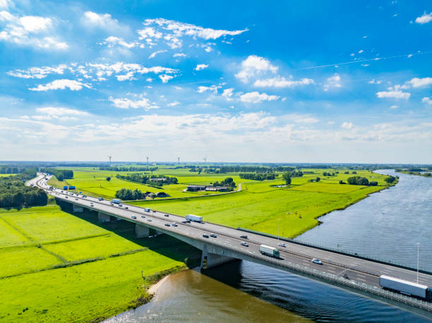 istock Highway over a bridge crossing a river seen from above 2022435666