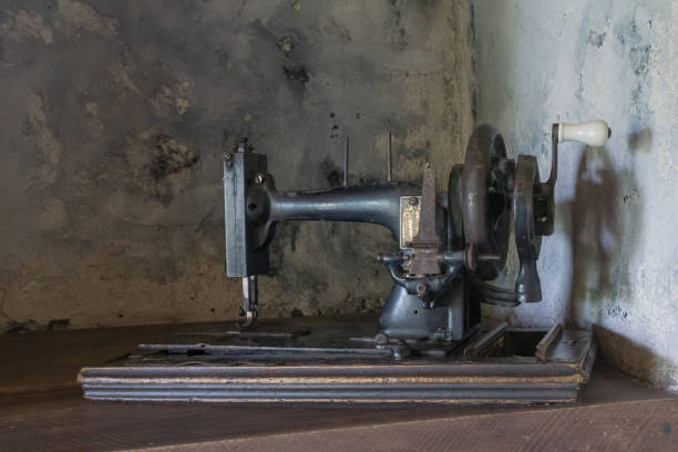Old manual sewing machine on the background of a cement wall. Georgia