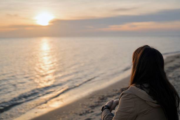 istock Beautiful woman relaxing on the beach 2022444457
