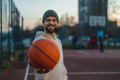 Smiling Sportsman in Basketball Court Looking at Camera