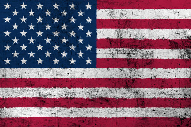 Colorful representation of the American flag appears on a rough concrete wall, symbolizing patriotism and national identity, capturing attention with its vivid colors.