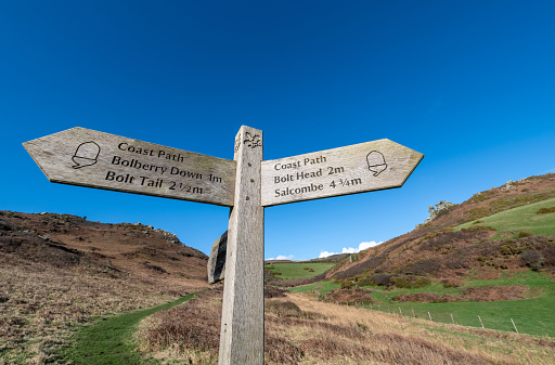 Bolberry Down, UK. 11 February 2024. National Trust and South West Coast Path sign at Bolberry Down in Devon