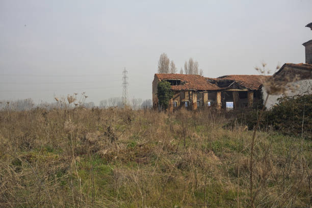 Barn in an abandoned country house next to a grass field