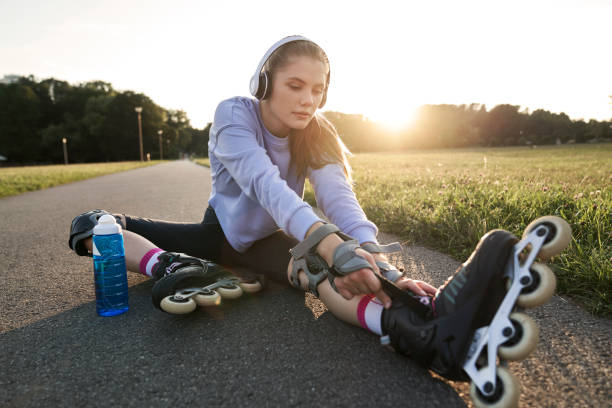 istock Woman preparing to rollerblade in the park 2022468849