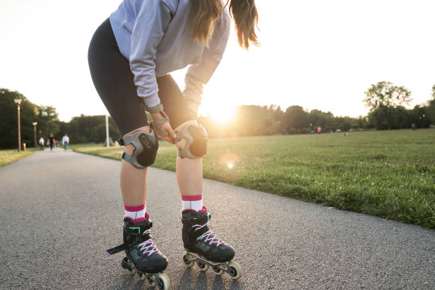 istock Young woman getting ready for  rollerblading in the park 2022469922